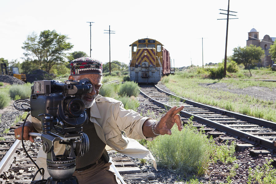African American man with film camera near railroad tracks Photograph by Marc Romanelli