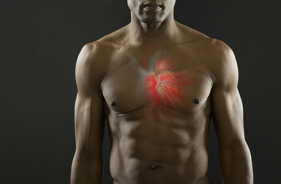 African American man with glowing heart Photograph by John M Lund Photography Inc