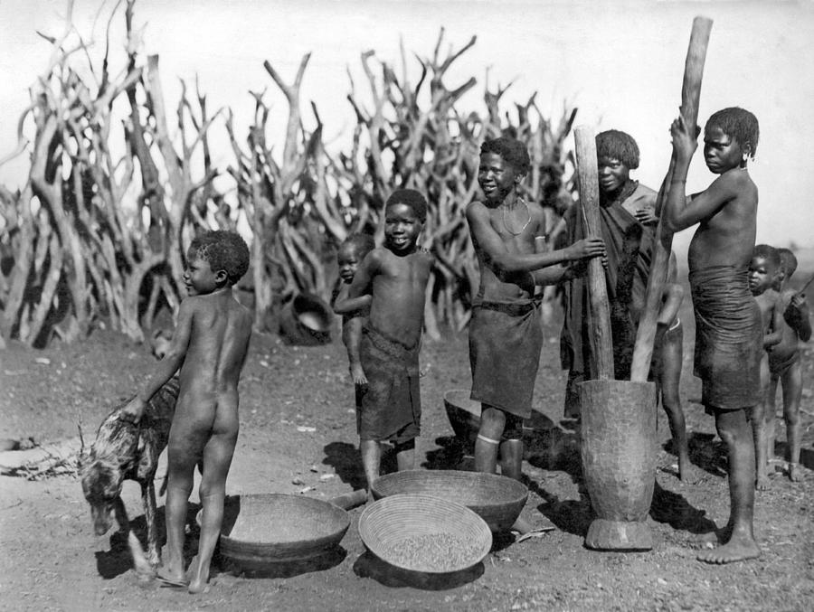 Vintage Photograph - African Girls Grinding Corn by Underwood Archives