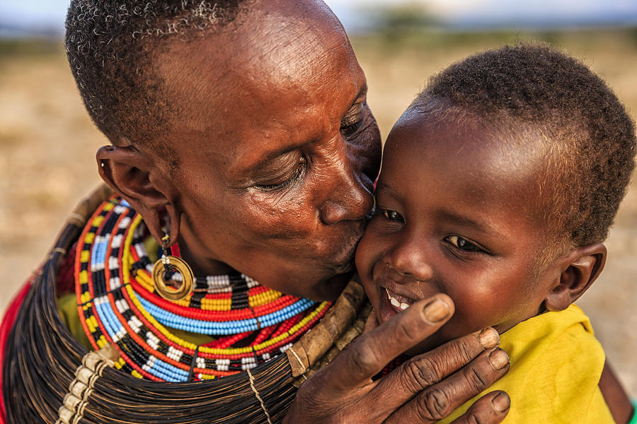 African woman kissing her baby, Kenya, East Africa Photograph by Bartosz Hadyniak