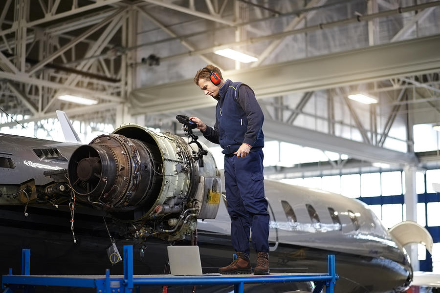 Aircraft mechanic in the hangar Photograph by Extreme-photographer