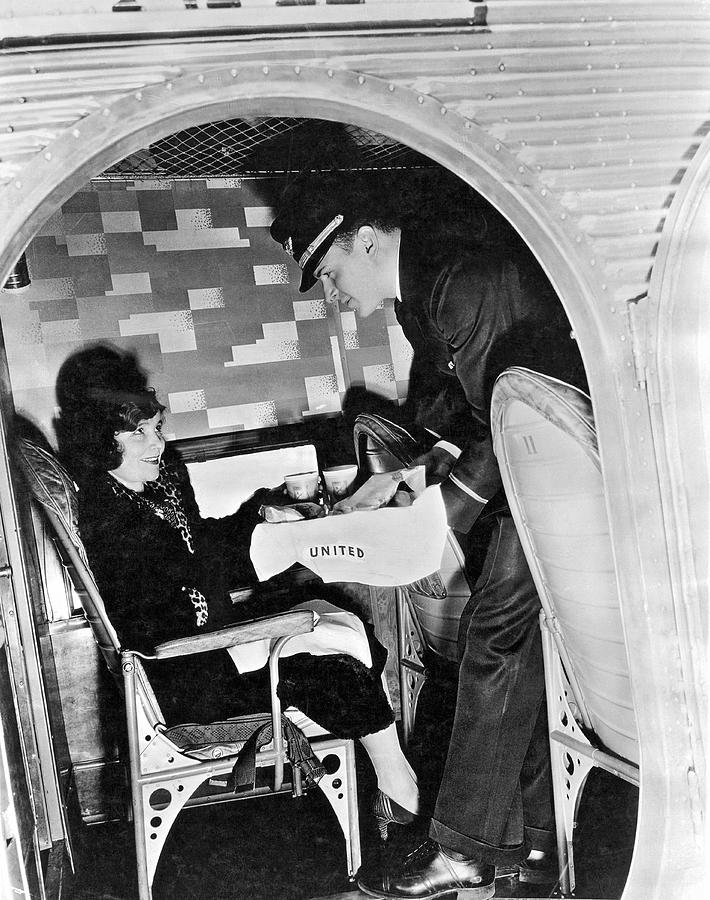 Airplane Photograph - Airline Steward Serves Woman by Underwood Archives