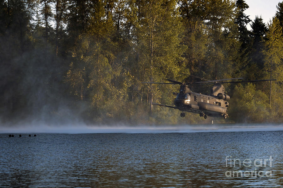 Airmen Wait In A Lake For An Mh-47 Photograph