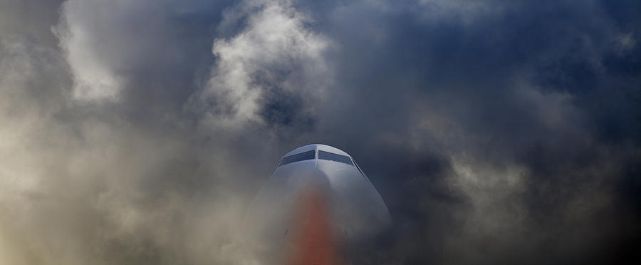 Airplane Flying Into Storm Photograph by Christian Lagereek