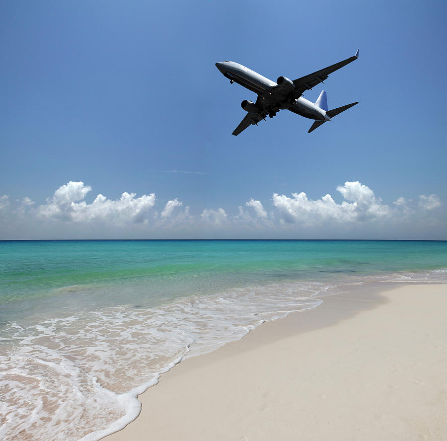 Airplane Flying Over A Deserted Beach Photograph by Buena Vista Images