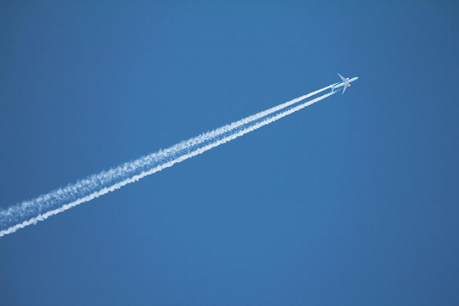 Airplane leaving vapor trail behind against blue sky Photograph by Bruno Guerreiro Airplane leaving vapor trail behind against blue sky Photograph by Bruno Guerreiro