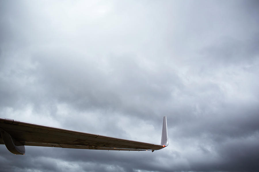 Airplane Wing And Storm Clouds Photograph by Ballyscanlon