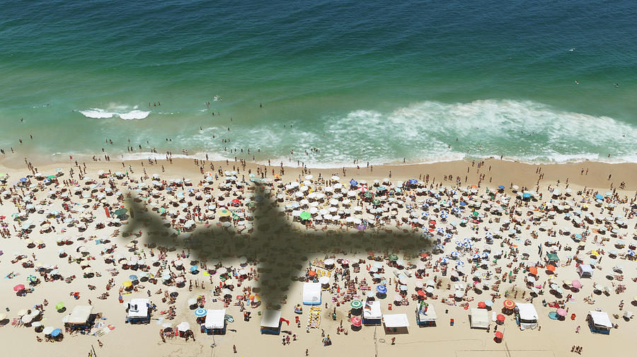 Airplanes Shadow Over A Crowded Beach Photograph by Buena Vista Images
