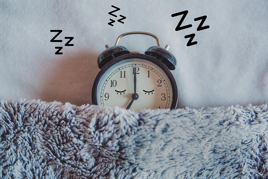 Alarm clock sleeping in bed Photograph by Carol Yepes