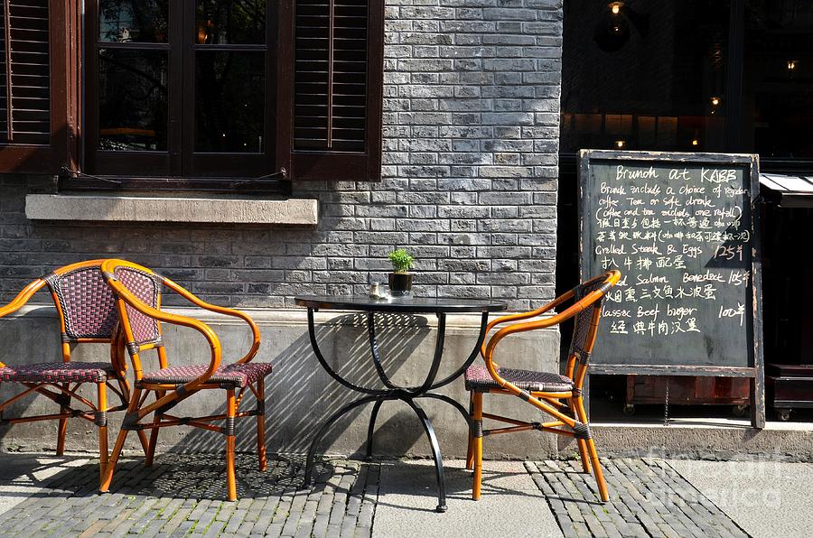 Alfresco restaurant table cane chairs and chalkboard menu Shanghai China Photograph by Imran Ahmed