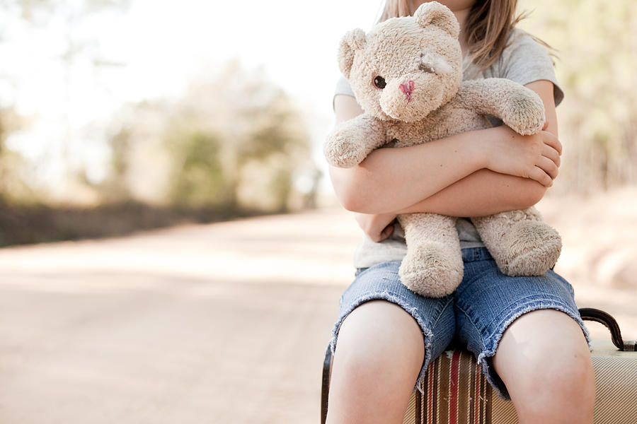 Alone Young Girl Hugging Old, Raggedy Teddy Bear Photograph by Ideabug