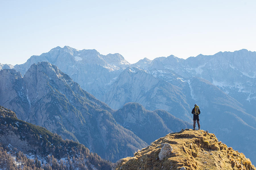Alpinist Enjoying the View Over the Mountains in the Alps Photograph by CasarsaGuru