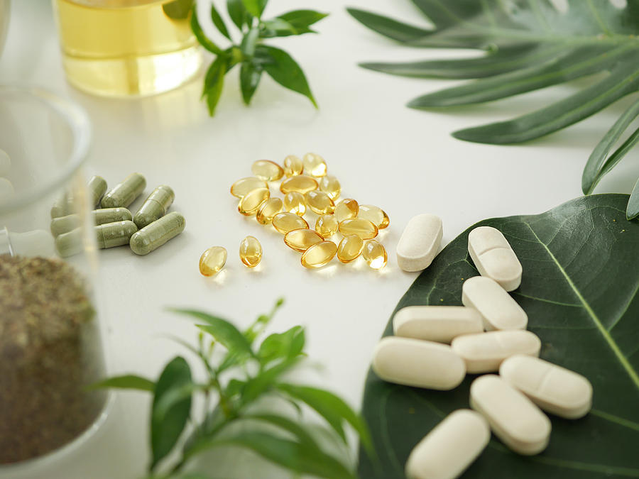 Alternative Herb Medicine. Herbal Vitamin On White Background. Photograph by Paulynn