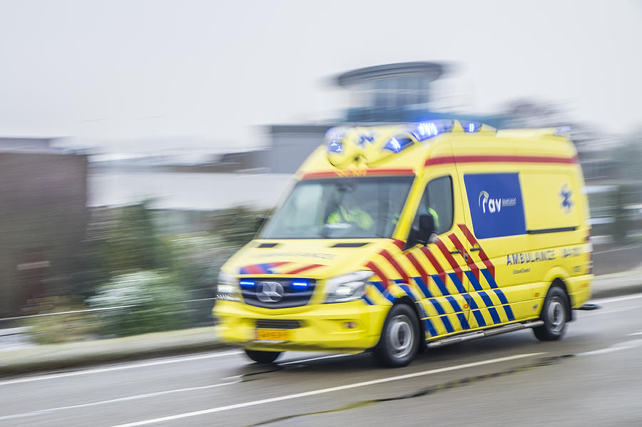 Ambulance rushing to an accident at high speed Photograph by Sjoerd van der Wal