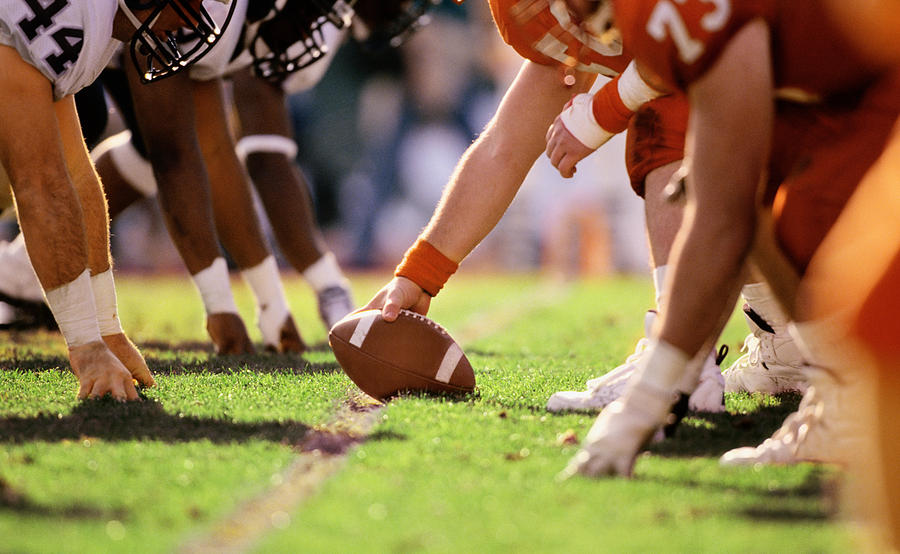 American football game, players at line of scrimmage, close-up Photograph by David Madison