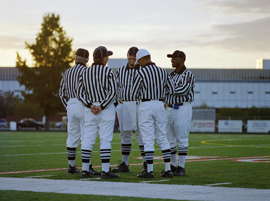 American football referees talking in field Photograph by Darrin Klimek