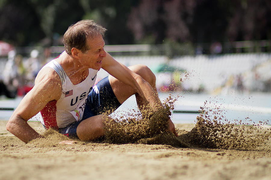 American Senior Competes In Long Jump Photograph by Alex Rotas