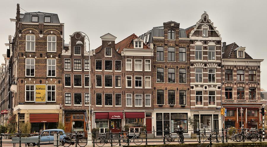 Amsterdam harbour houses Photograph by Mick Flynn