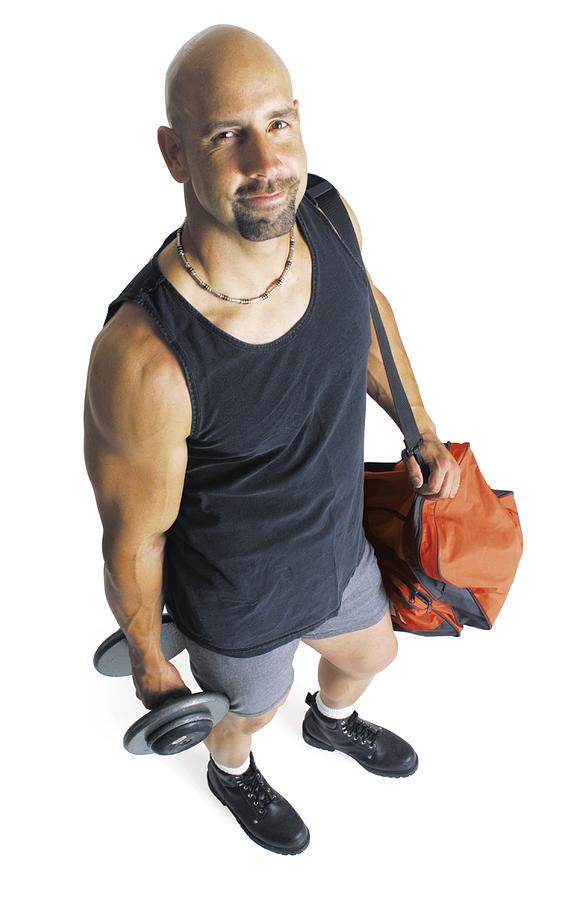 An Adult Caucasian Male Weightlifter In A Black Tank Top Holding A Dumbell And His Gear Stands And Looks Up At The Camera Photograph by Photodisc