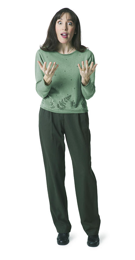 An Adult Caucasian Woman In A Green Sweater Gestures With Her Hands As She Appears Shocked Photograph by Photodisc