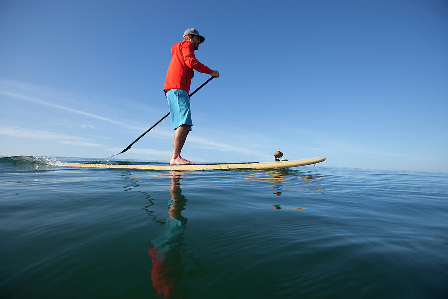 An Adult Man Stand Up Paddle Boarding Photograph By Woods Wheatcroft 