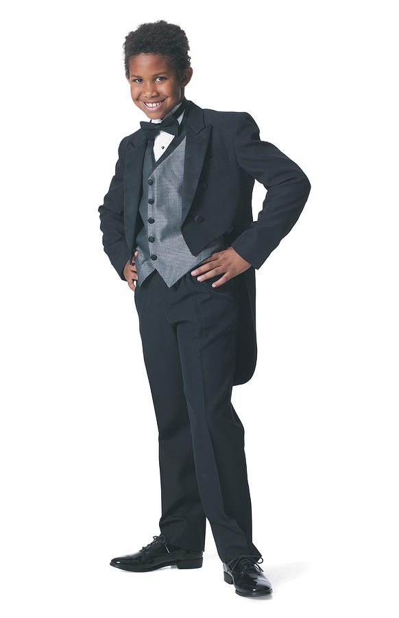 An African American Boy Dressed In A Tuxedo Puts His Hands On His Hips And Smiles Photograph by Photodisc