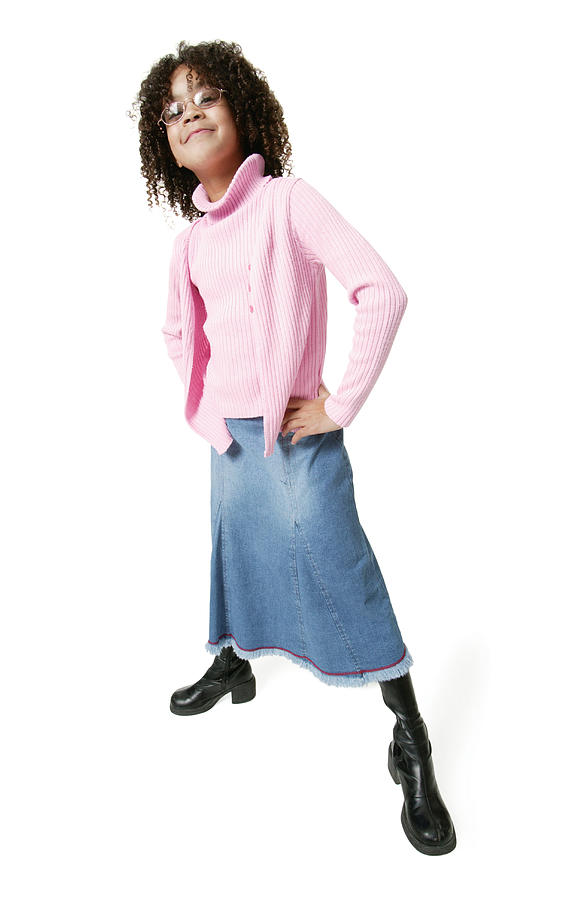 An African American Girl In Skirt Jeans And A Pink Sweater Puts Her Hands On Her Hips And Smiles Photograph by Photodisc