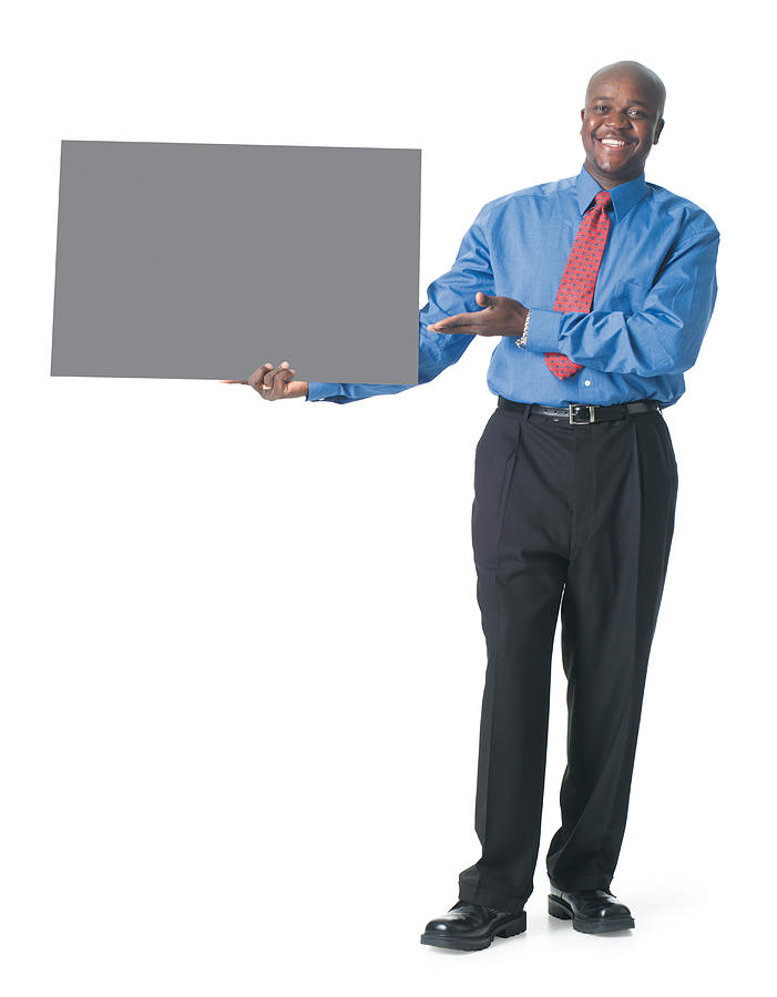 An African American Male In Black Pants And A Blue Dress Shirt Holds A Blank Sign To His Side And Gestures To It Photograph by Photodisc