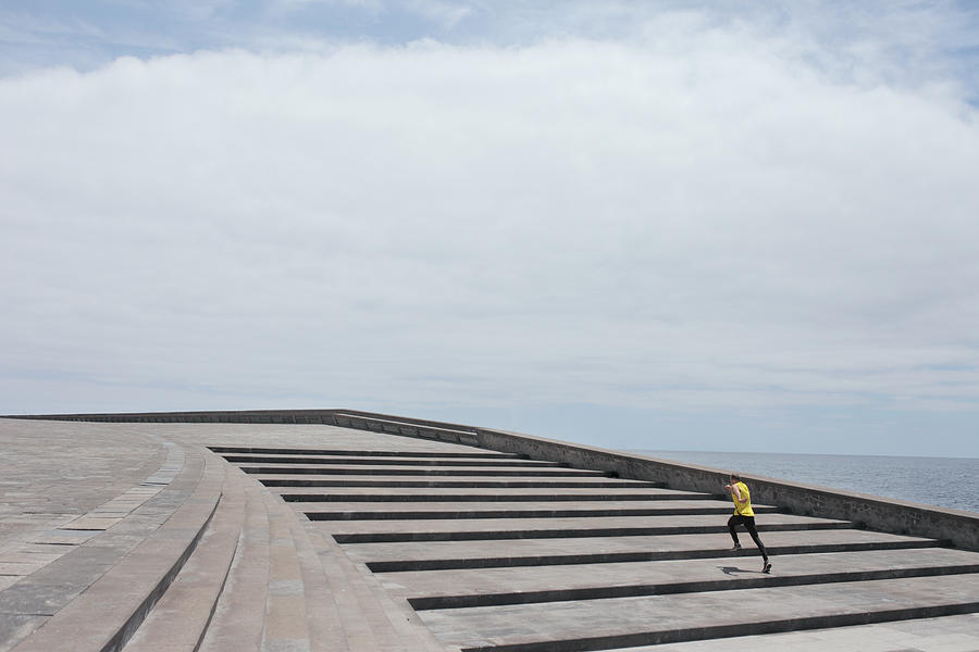 An alone man running up large stairs Photograph by Stanislaw Pytel
