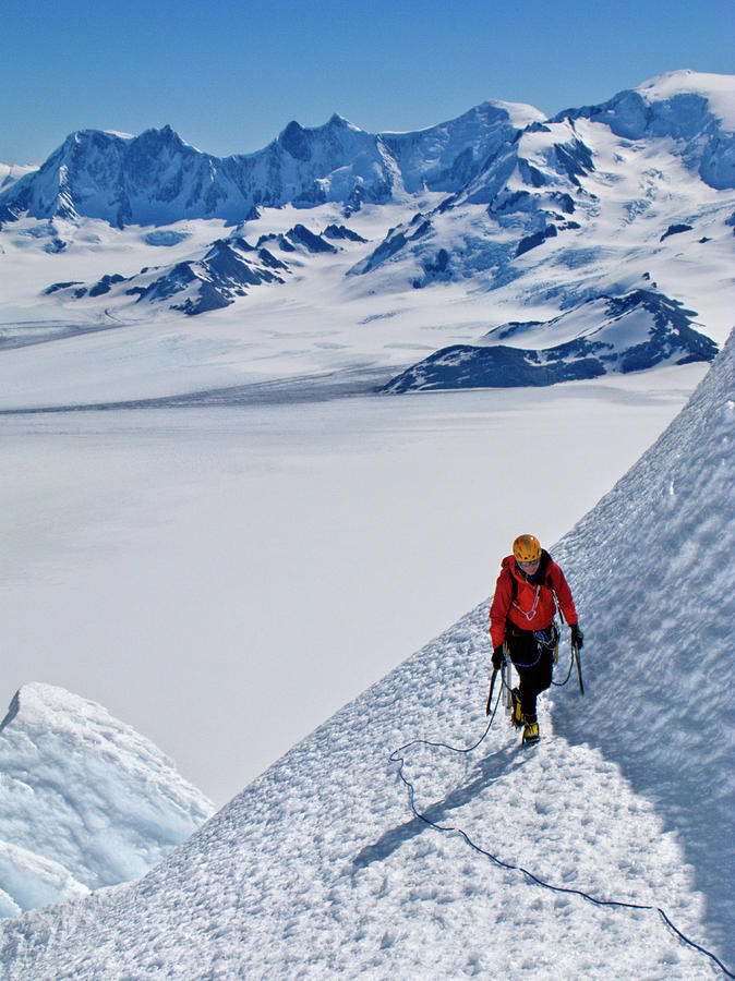 An Alpinist Climbs An Ice Slope Photograph by Rolando Garibotti
