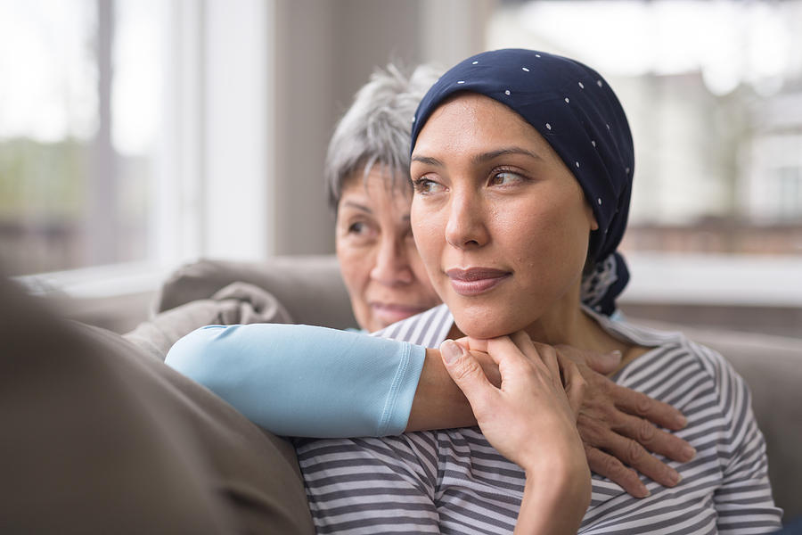 An Asian woman in her 60s embraces her mid-30s daughter who is battling cancer Photograph by FatCamera An Asian woman in her 60s embraces her mid-30s daughter who is battling cancer Photograph by FatCamera