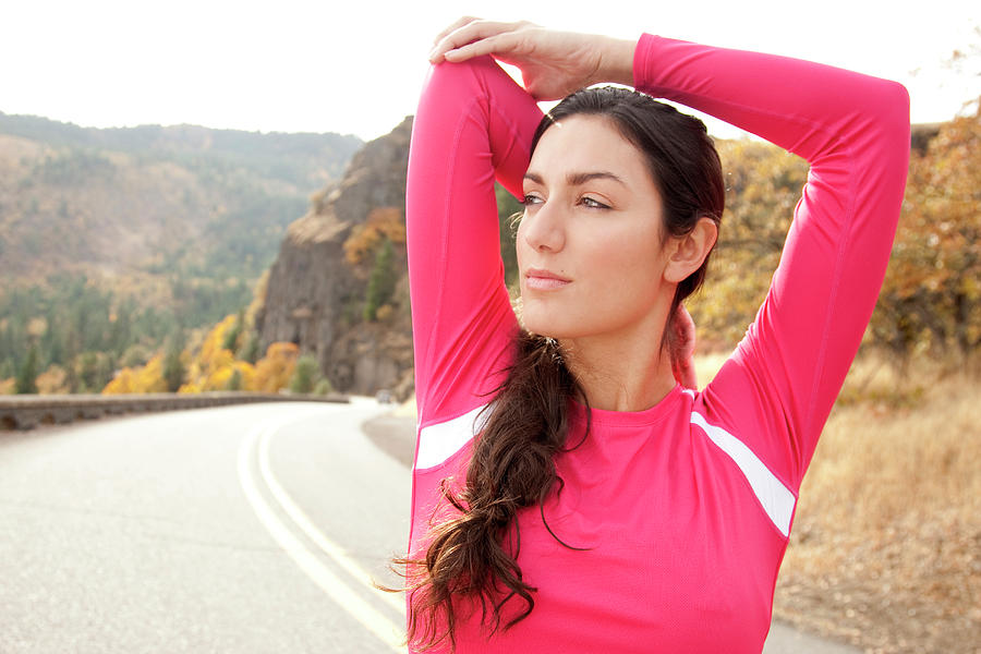 An Athletic Female Stretches Photograph By Jordan Siemens Fine Art