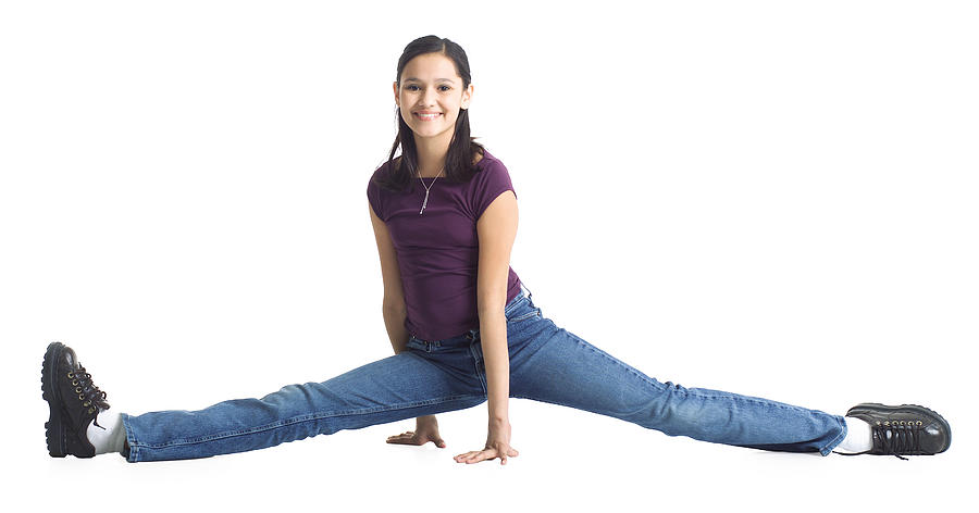 An Ethnic Teenage Girl In Jeans And A Purple Shirt Does The Splits Photograph by Photodisc