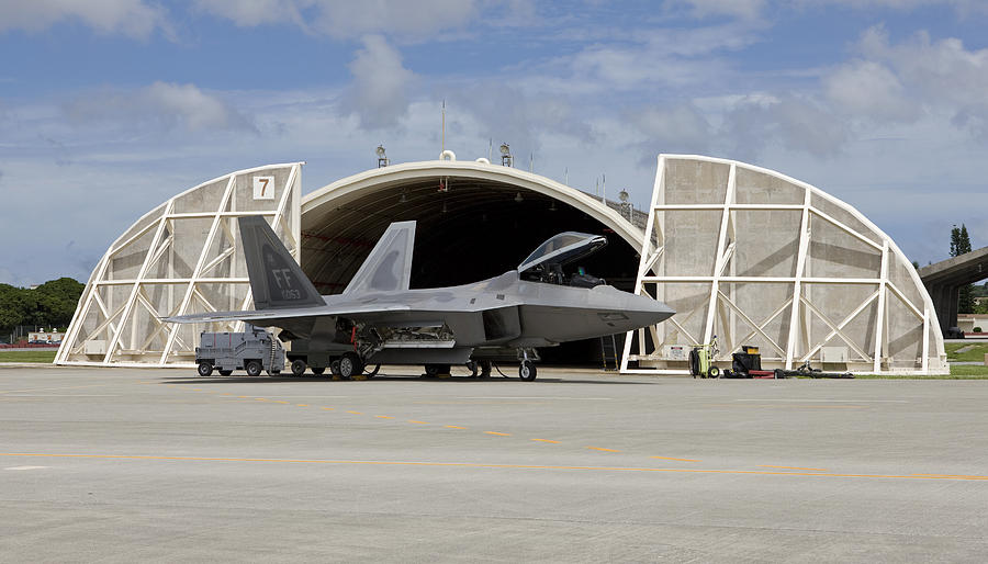 An F-22 Raptor from Langley Air Force Base, Virginia, sits in front of a hardened aircraft shelter at Kadena Air Base, Okinawa. Photograph by HIGH-G Productions/Stocktrek Images