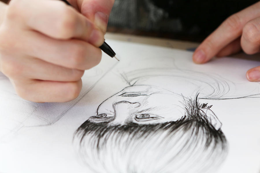 An illustrator working on a drawing Photograph by Nicola Tree