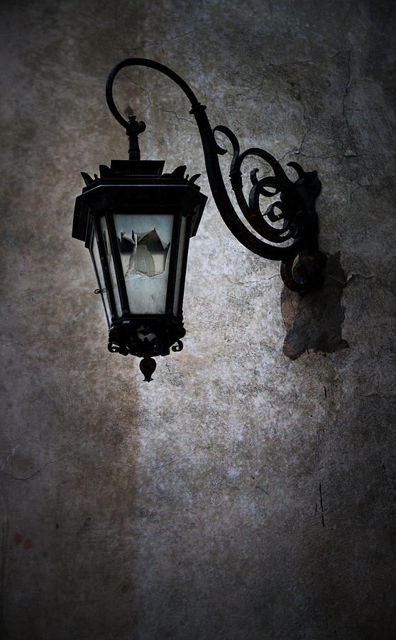 An old broken street lantern on the wall Photograph by Jaroslaw Blaminsky