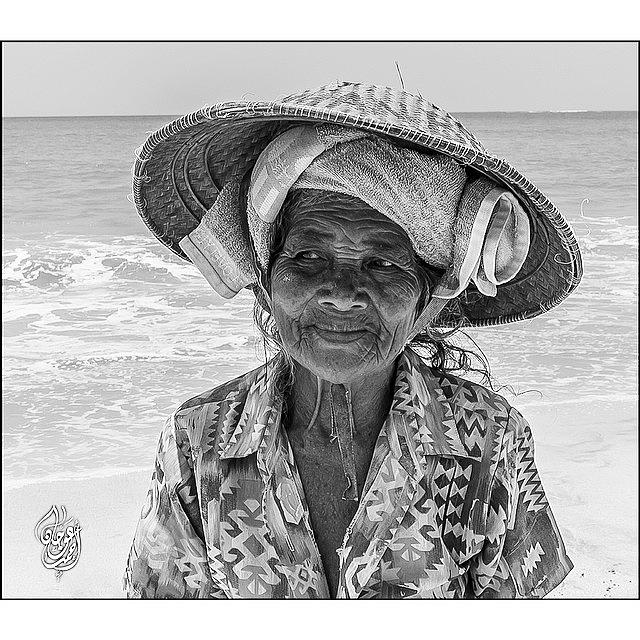 Nature Photograph - An Old Lady By The Seashore Collecting by Ahmed Oujan