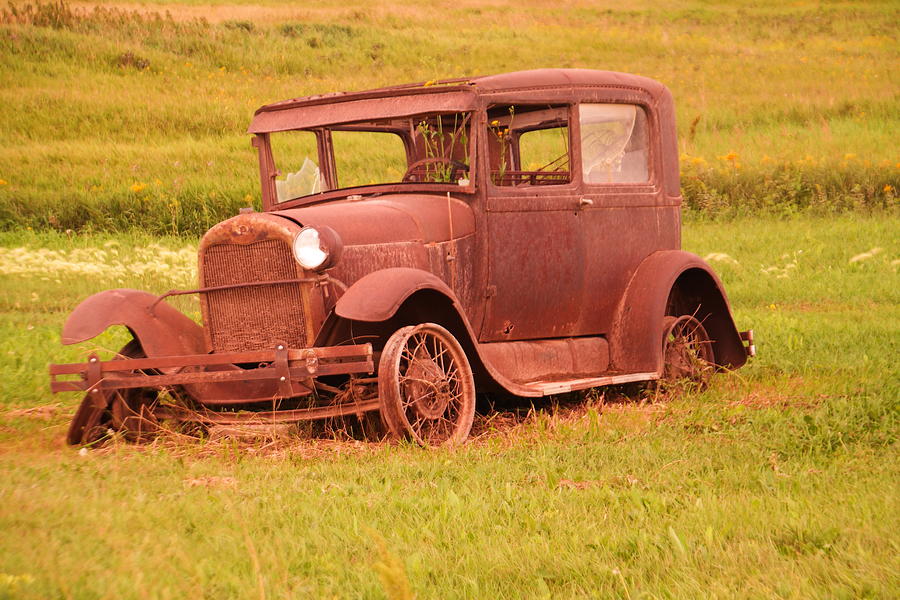 An old rusty car Photograph by Jeff Swan