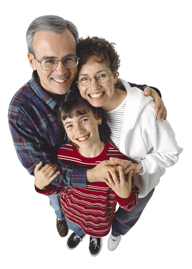 An Older Caucasian Couple Hugs Their Preteen Daughter Photograph by Photodisc