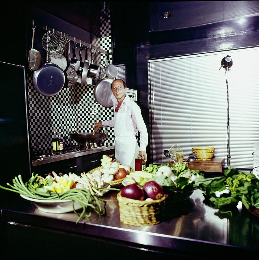 Angelo Donghia In His Kitchen Photograph by Horst P. Horst