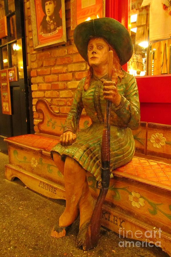 Wood Carvings Photograph - Annie got her Gun at Wall Drug by John Malone