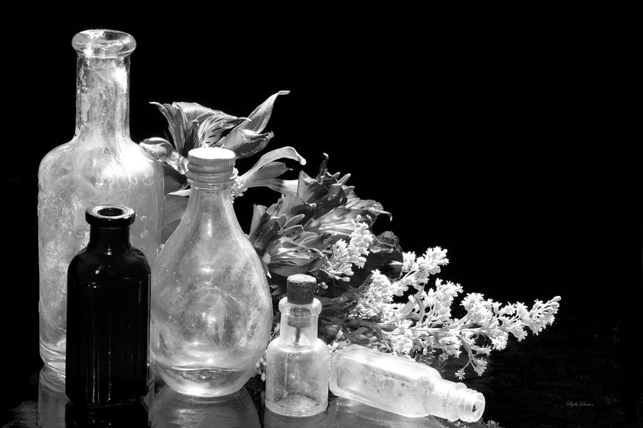 Antique Bottles And Flowers Black And White Photograph by Phyllis Denton