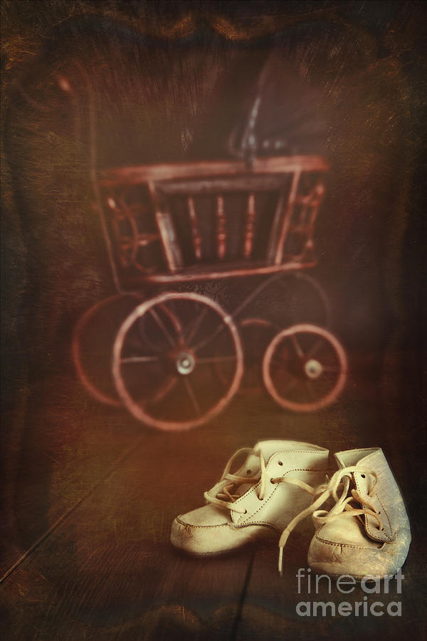 Antique doll carriage with baby shoes in foreground Photograph by Sandra Cunningham