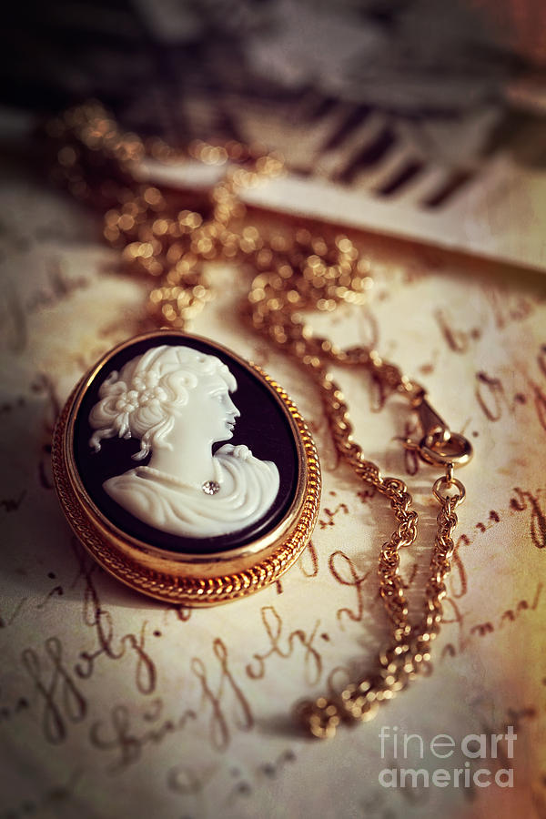 Antique gold cameo laying on a letter and photos Photograph by Sandra Cunningham