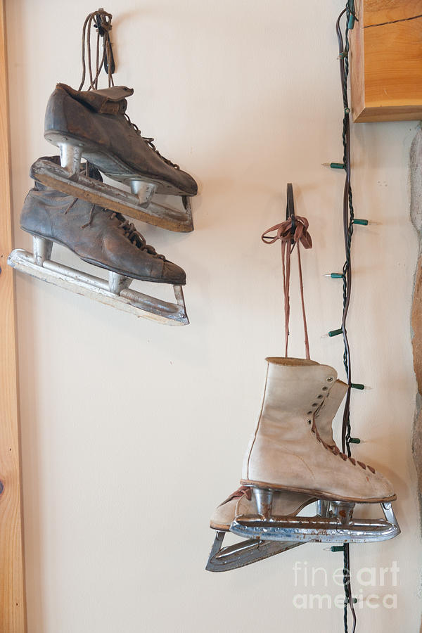 Antique ice skates hanging on a wall. Photograph by Don Landwehrle