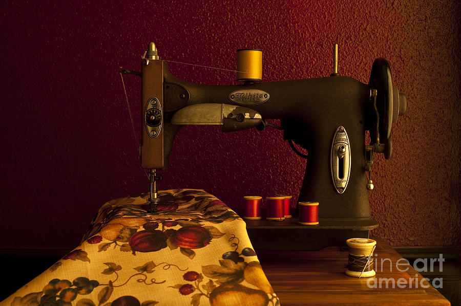 Antique sewing machine with spools and thread and fabric Photograph by Jim Corwin
