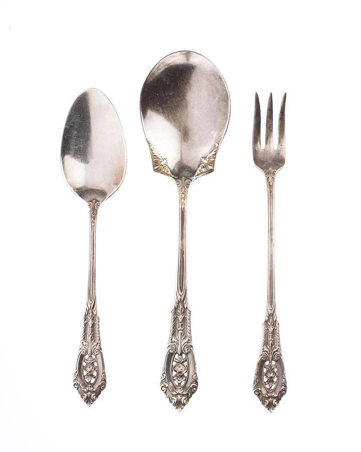 Antique silver spoons and fork on white background Photograph by Twohumans
