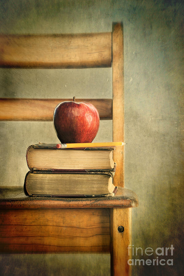 Apple and old books on school chair Photograph by Sandra Cunningham