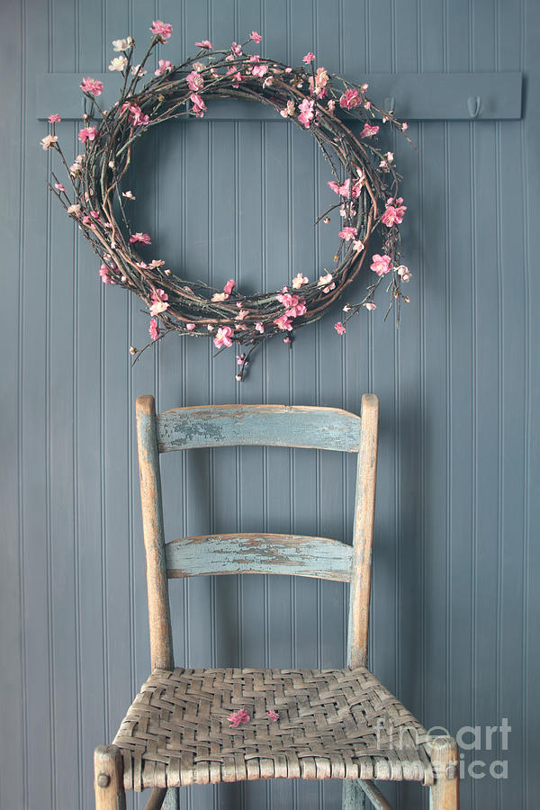 Apple blossom wreath hanging on coat hook with chair Photograph by Sandra Cunningham