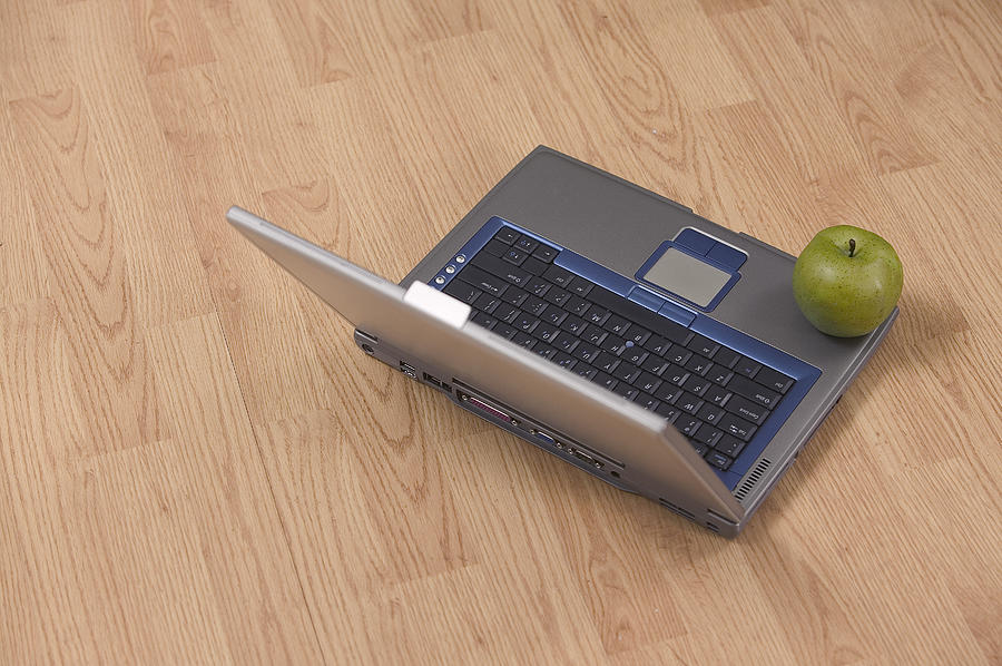 Apple on laptop Photograph by Comstock Images